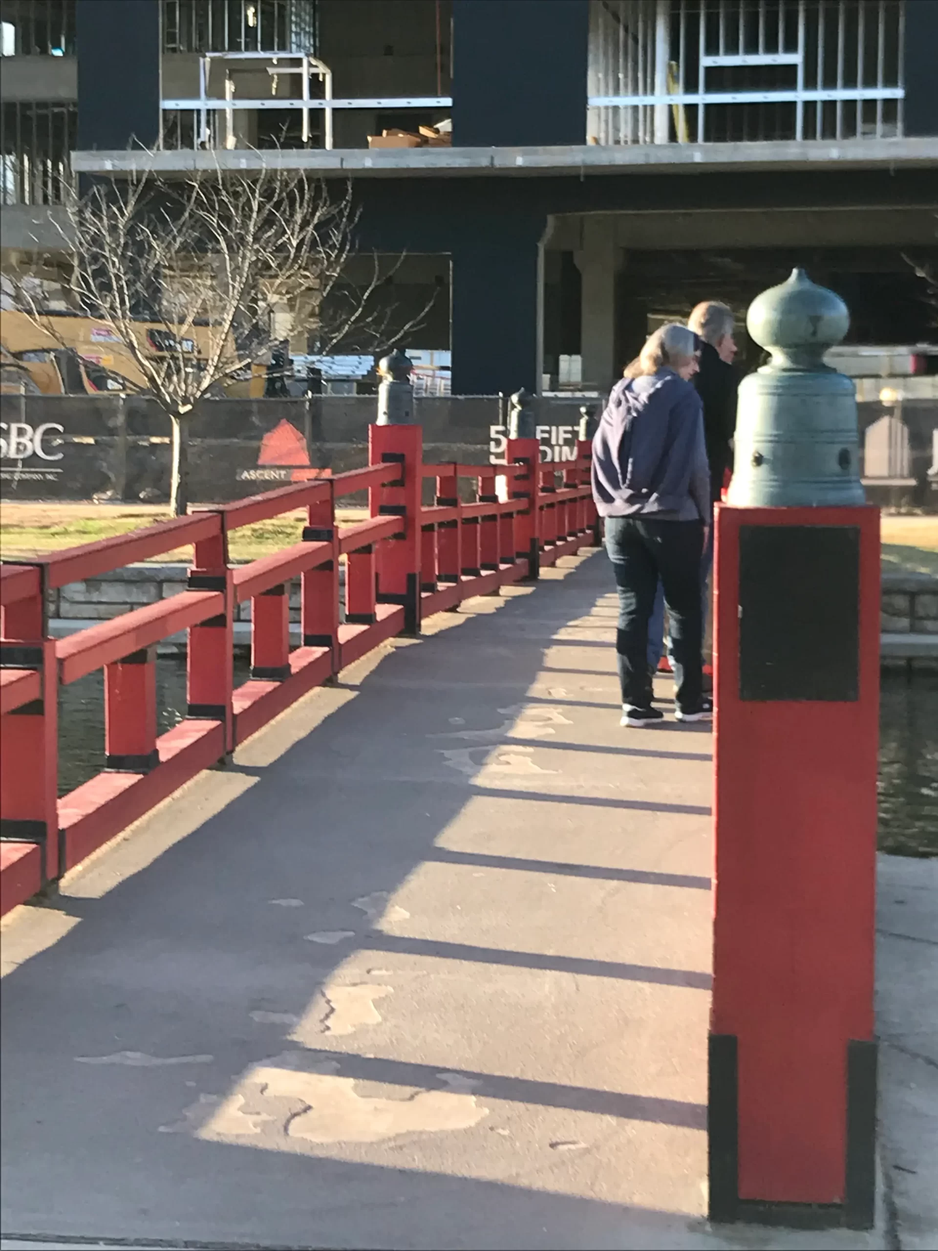 Festive Atmosphere and Iconic Red Bridge at Big Spring Park
